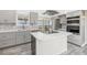 Well-lit kitchen showcasing ample counter space, modern appliances, and gray cabinetry at 1923 Ensenada Ct, Aurora, CO 80011