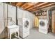 Basement laundry room featuring a washing machine, dryer and laundry sink at 1923 Ensenada Ct, Aurora, CO 80011
