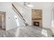 Bright living room features a stone fireplace and staircase, creating an inviting and open space at 1923 Ensenada Ct, Aurora, CO 80011