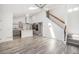 Open concept kitchen features stone fireplace and center island with cooktop, refrigerator and double oven at 1923 Ensenada Ct, Aurora, CO 80011