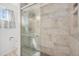Modern tiled shower with glass door and updated shower head fixture at 1923 Ensenada Ct, Aurora, CO 80011