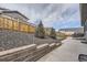 Landscaped backyard with retaining wall at 2905 Morningbird Ln, Castle Rock, CO 80109