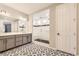 Modern bathroom featuring double vanity, patterned tile floor, and glass-enclosed shower with black accents at 2905 Morningbird Ln, Castle Rock, CO 80109