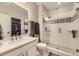 Bright bathroom featuring a glass enclosed shower, white vanity, and a walk-in closet at 2905 Morningbird Ln, Castle Rock, CO 80109
