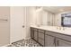 Elegant bathroom with double vanity and patterned floor at 2905 Morningbird Ln, Castle Rock, CO 80109