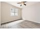 Simple bedroom with ceiling fan and wood-look floors at 2905 Morningbird Ln, Castle Rock, CO 80109