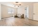 Bedroom with L-shaped sofa, ceiling fan, and wood-look floors at 2905 Morningbird Ln, Castle Rock, CO 80109