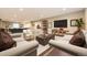 Spacious living area with neutral furniture, trunk coffee table, and large screen television at 2905 Morningbird Ln, Castle Rock, CO 80109