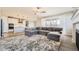 Open concept living room and kitchen featuring modern appliances, gray wood flooring, and ample natural light at 2905 Morningbird Ln, Castle Rock, CO 80109