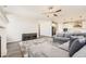 Open concept living room featuring modern decor, gray wood flooring, and seamless flow to kitchen at 2905 Morningbird Ln, Castle Rock, CO 80109
