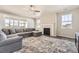 Spacious living room featuring a cozy fireplace and large windows at 2905 Morningbird Ln, Castle Rock, CO 80109