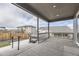Covered outdoor patio with hot tub overlooking a fenced backyard at 2905 Morningbird Ln, Castle Rock, CO 80109