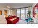 Living room with red couch and sliding glass door to balcony at 4800 E Hale Pkwy # 709N, Denver, CO 80220