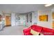 Bright living room with red couch and built-in shelving at 4800 E Hale Pkwy # 709N, Denver, CO 80220