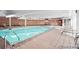 Indoor pool with brick walls and lounge chairs at 4800 E Hale Pkwy # 709N, Denver, CO 80220
