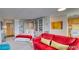 Studio apartment with sleeping area and red couch at 4800 E Hale Pkwy # 709N, Denver, CO 80220