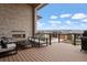 Deck with fireplace, seating area, and mountain views at 1196 Lost Elk Loop, Castle Rock, CO 80108