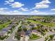 Residential area with lush green fairways, landscaped lawns, and houses with diverse architectural styles at 22166 E Chestnut Pl, Aurora, CO 80016