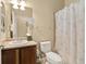 Bathroom with vanity sink, toilet, and shower with decorative curtain at 22166 E Chestnut Pl, Aurora, CO 80016