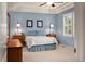 Charming bedroom with a tray ceiling, blue walls, carpet flooring and comfortable bed at 22166 E Chestnut Pl, Aurora, CO 80016