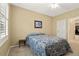 Bedroom with a cozy bed, ceiling fan, and bright window for natural light at 22166 E Chestnut Pl, Aurora, CO 80016