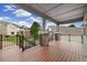 Spacious covered deck with wood flooring and wrought iron railing provides serene outdoor living space at 22166 E Chestnut Pl, Aurora, CO 80016