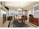 Dining room with fireplace, chandelier, wood table, and bay windows providing natural light at 22166 E Chestnut Pl, Aurora, CO 80016