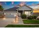 Charming single-Gathering home featuring a covered front porch, well-kept lawn, and attached two-car garage at 22166 E Chestnut Pl, Aurora, CO 80016