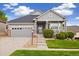 Charming single-Gathering home featuring a covered front porch, well-kept lawn, and attached two-car garage at 22166 E Chestnut Pl, Aurora, CO 80016
