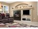 Relaxing living room featuring a fireplace, television, and a comfortable leather chair at 22166 E Chestnut Pl, Aurora, CO 80016