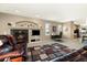 Comfortable living room featuring a cozy fireplace, entertainment center, and plush seating with a patterned rug at 22166 E Chestnut Pl, Aurora, CO 80016