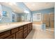 Main bathroom with double sink, tub, shower and big mirror at 22166 E Chestnut Pl, Aurora, CO 80016