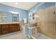 Main bathroom featuring a glass shower, tub, wood cabinets, and tiled walls at 22166 E Chestnut Pl, Aurora, CO 80016