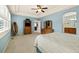 Spacious main bedroom with a ceiling fan, carpet flooring, and access to the main bathroom at 22166 E Chestnut Pl, Aurora, CO 80016
