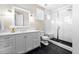 Modern bathroom with white cabinets, black tile floor, and subway tile shower at 117 Flowerburst Way, Highlands Ranch, CO 80126