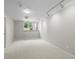Spacious basement with large window for light, neutral walls, and carpet, a versatile space for recreation or storage at 584 Ridgeview Dr, Louisville, CO 80027