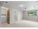Finished basement includes a washer/dryer, bathroom with a stand-up shower, carpet, and natural light from the window at 584 Ridgeview Dr, Louisville, CO 80027