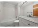Clean bathroom featuring a shower-tub combo, gray tile floor, and updated vanity with granite countertops at 584 Ridgeview Dr, Louisville, CO 80027