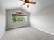 Bright bedroom with neutral walls, plush carpet, and a large window providing ample natural light and backyard views at 584 Ridgeview Dr, Louisville, CO 80027