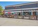 Exterior view of Main Street Marketplace with a brewery and pub, featuring colorful umbrellas and outdoor seating at 584 Ridgeview Dr, Louisville, CO 80027