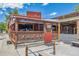 Exterior of a casual bar with a wooden deck, neon signs, and outdoor seating, exuding a lively atmosphere at 584 Ridgeview Dr, Louisville, CO 80027