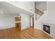 Open-concept living area with a fireplace, stairs, and kitchen area at 584 Ridgeview Dr, Louisville, CO 80027