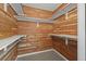 Spacious walk-in closet featuring a cedar plank wall design and white shelving for optimal storage and organization at 584 Ridgeview Dr, Louisville, CO 80027