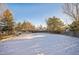 Large backyard with a snow-covered lawn and wooden fence at 2786 E 118Th Cir, Thornton, CO 80233