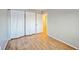 Simple bedroom with light gray walls, laminate flooring, and neutral curtains at 2786 E 118Th Cir, Thornton, CO 80233