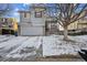 Two-story house with gray siding, attached garage, and snowy front yard at 2786 E 118Th Cir, Thornton, CO 80233