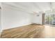 Bedroom featuring light wood floors, white walls and ceiling beams, and sliding glass door to balcony at 100 S Clarkson St # 304, Denver, CO 80209