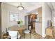 Dining area featuring a wood table, white chairs, and stainless steel refrigerator at 100 S Clarkson St # 304, Denver, CO 80209