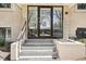 Building entrance with glass doors, gray steps, and landscaping detail at 100 S Clarkson St # 304, Denver, CO 80209