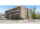 Apartment building exterior with balconies and lush landscaping at 100 S Clarkson St # 304, Denver, CO 80209